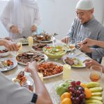 Family Muslim Togetherness On Eid Celebration At Dining Room With Various Special Food On The Table